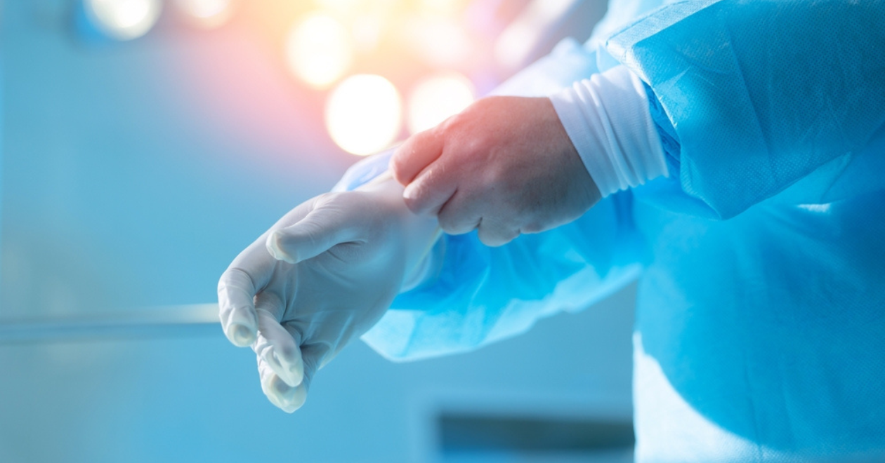 Surgeon putting on gloves for surgery