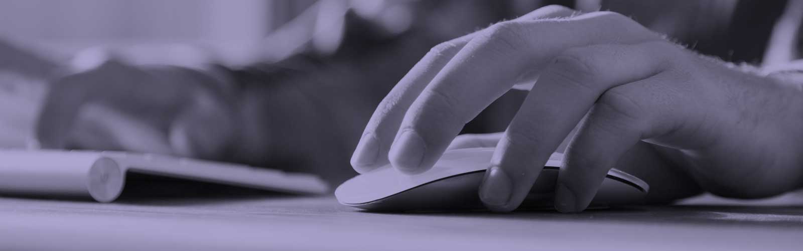 A person using a computer mouse and keyboard