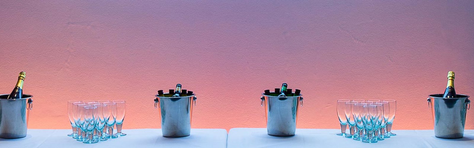 Wine glasses and ice buckets with wine and champagne bottles