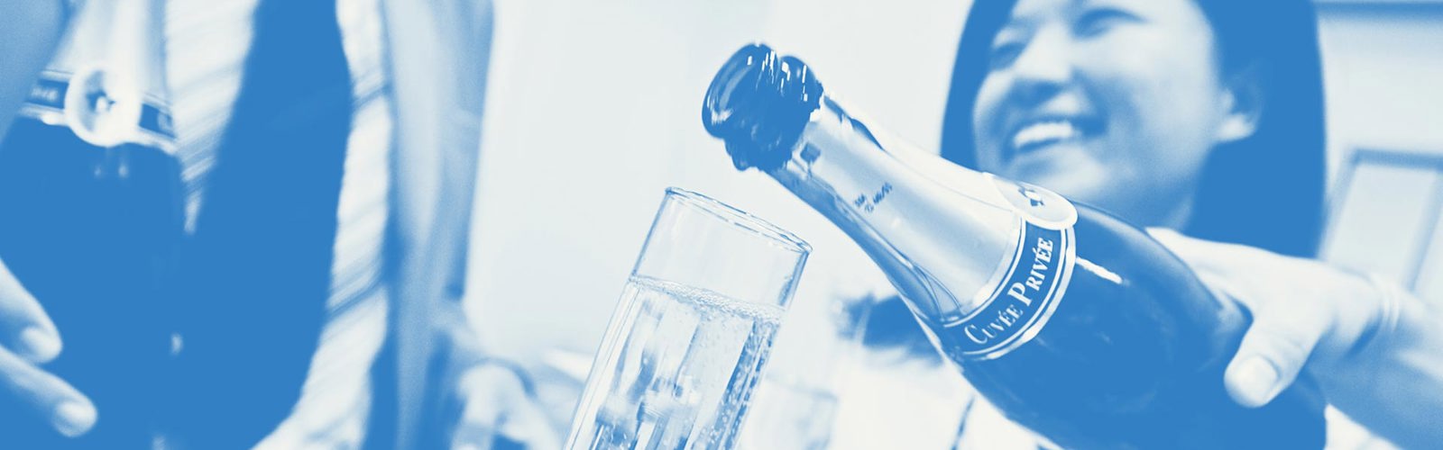 Smiling woman with a drink being poured in the foreground