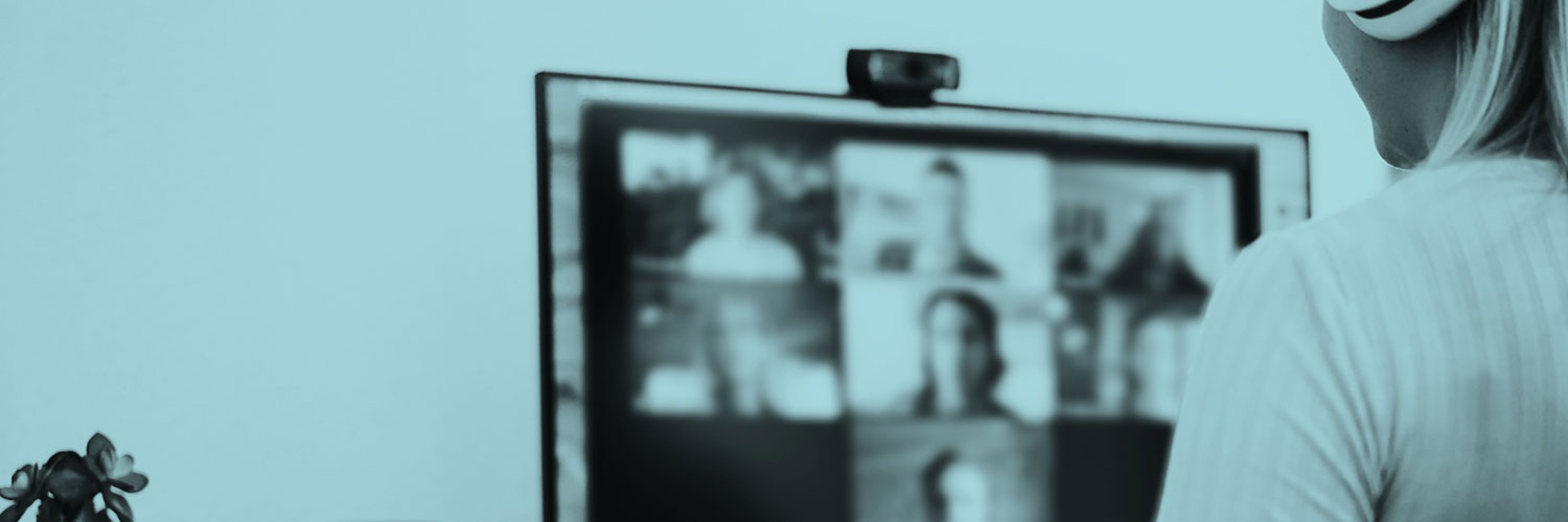 A person sitting in front of a computer screen