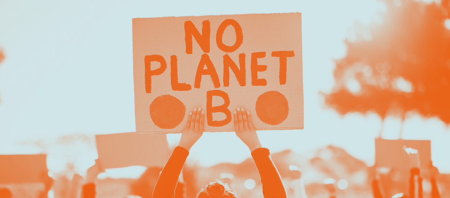 Person holding a sign that says 'No Planet B'