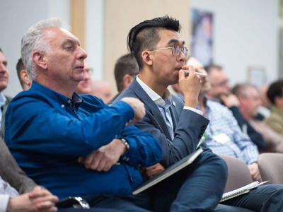 Delegates taking notes during a speaker session in the Elements Suite