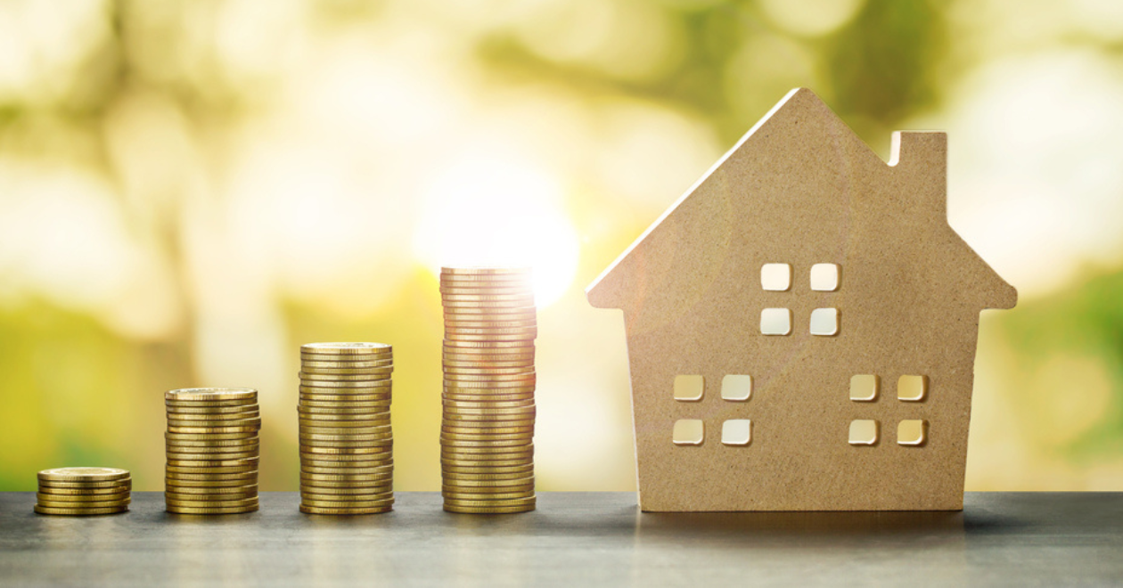 House Model and Golden Coins Stacks with blur Background