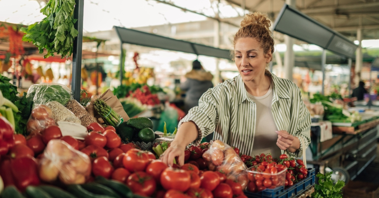 Person browsing at vegetable stalls