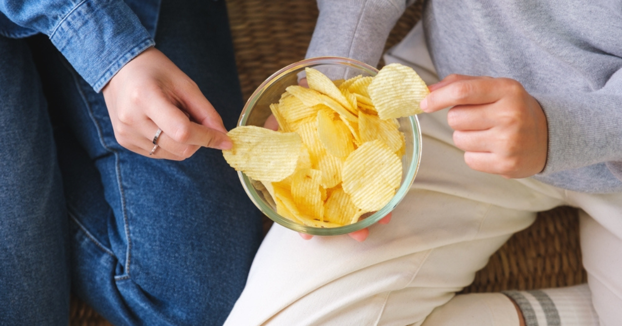Friends sharing a bowl of crisps